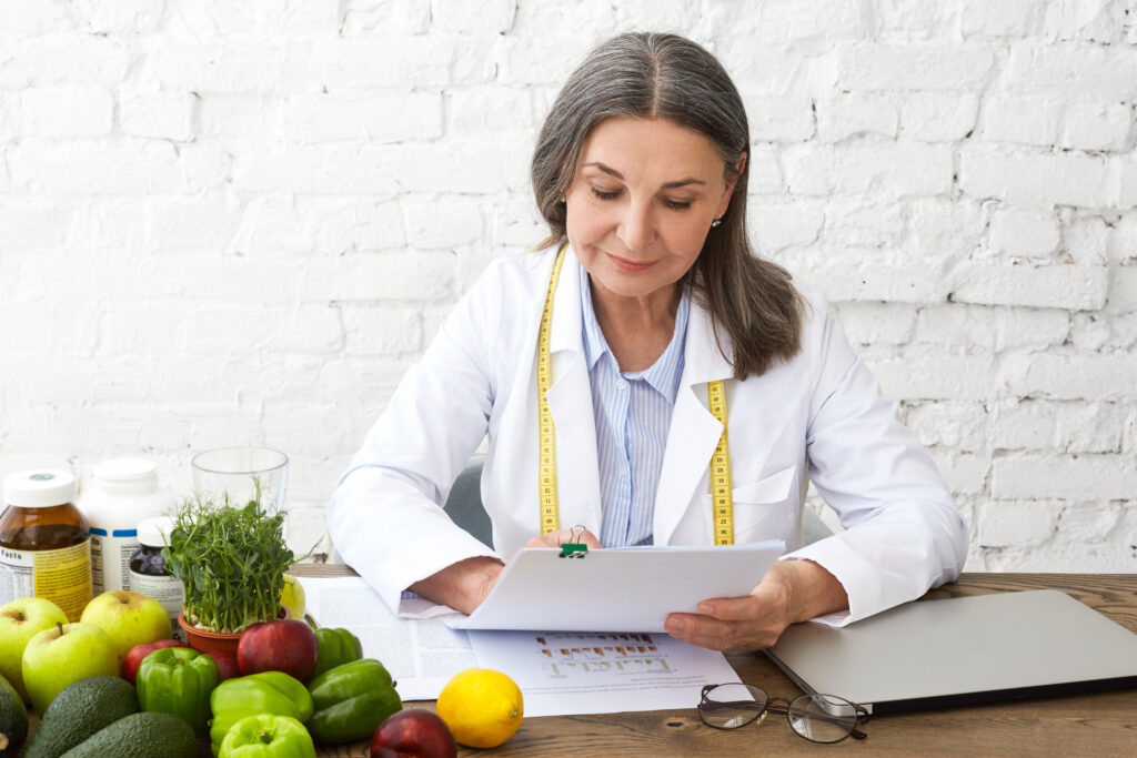 Doctor reviewing a personalized medical weight loss plan with healthy foods and nutrition guidance