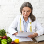 Doctor reviewing a personalized medical weight loss plan with healthy foods and nutrition guidance