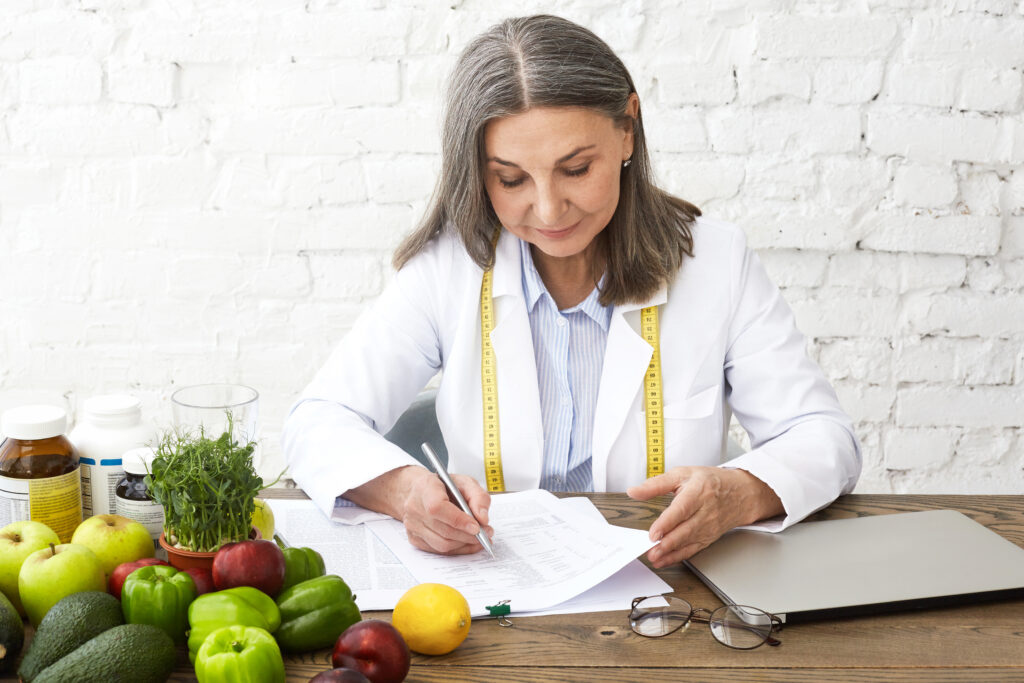 Doctor holding medical documents during a weight loss consultation