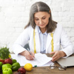 Doctor holding medical documents during a weight loss consultation